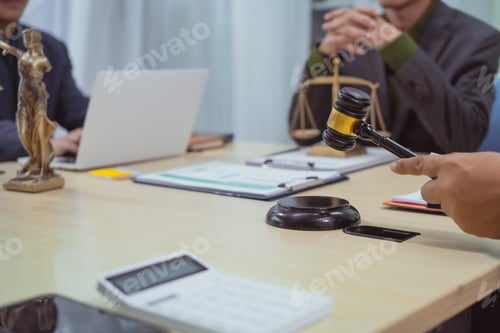 Preview: Three lawyers in a meeting at the table in an office, discussing business,civil and commercial law