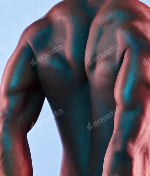 Preview: Shot of a muscular man posing against a studio background