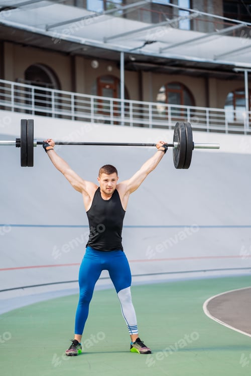 Preview: Young guy raises the bar in the stadium, outdoor workout
