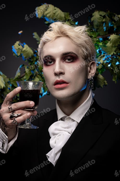 Preview: Young handsome man showcases epic Halloween costume with dark glamour at a festive gathering
