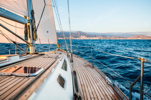 Preview: Sailboat and coastline in background - concept of travel and enjoy freedom on boat
