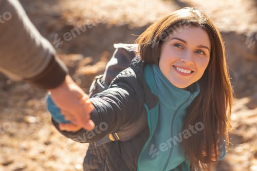 Preview: Portrait of happy young woman outstretching hand to man