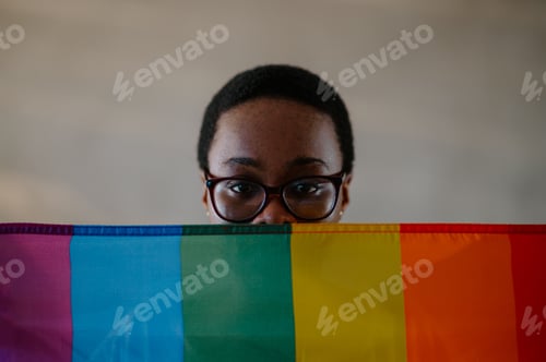 Preview: Portrait of a lesbian african american woman holding gay lgbt flag