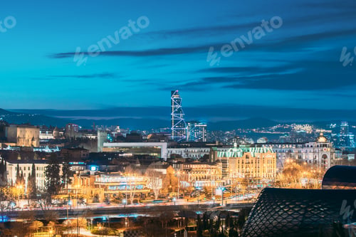 Preview: Tbilisi, Georgia. modern highrise building in Urban Cityscape during evening lights. Elevated view