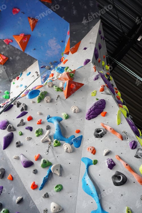 Preview: a boulder wall with many different climbing equipment on it in a gym