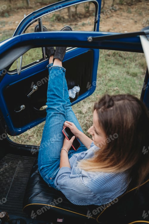 Preview: Woman daydreaming inside car