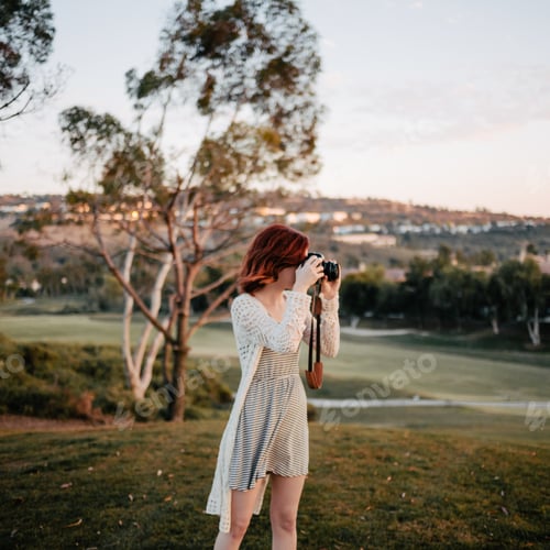 Woman with Camera Taking Pictures in Nature