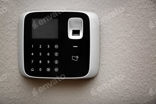 Preview: Modern alarm system with fingerprint scanner on light wall. Space for text