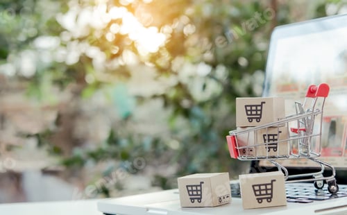 Preview: Shopping online. cardboard box with a shopping cart logo in a trolley on laptop keyboard.