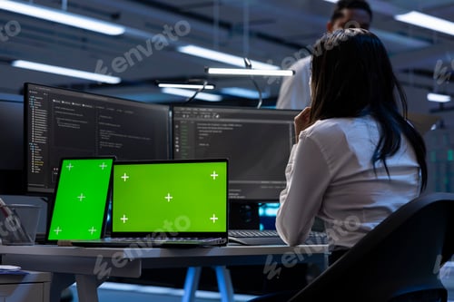 Preview: Technician in data center using isolated screen tablet and laptop
