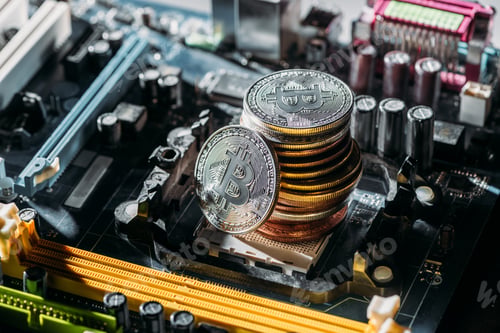Preview: close up view of pile of bitcoins on computer motherboard