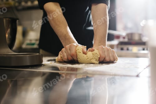 Preview: Close up. The cook kneads the dough with his hands, making macaroons or cakes.