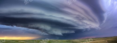 Preview: Large arcus cloud sweeps around the updraft of anticyclonic supercell with sunset colors projected