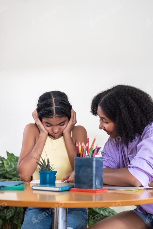 Preview: Young student learning from tutor during study session