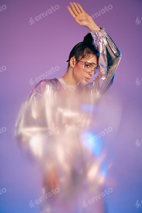 Preview: Stylish woman showcasing holographic fashion in a vibrant futuristic setting