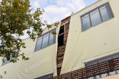 Preview: old brick house covered with decorative fabric