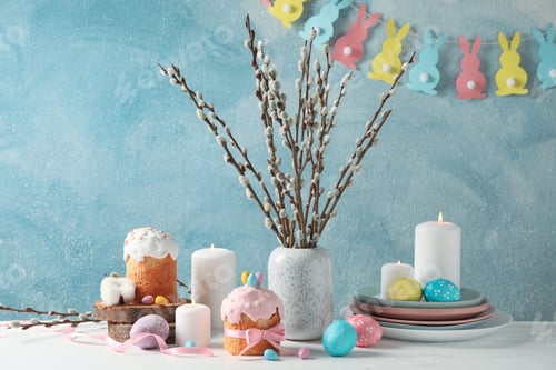 Preview: Easter concept with Easter cakes and candles on wooden table, space for text