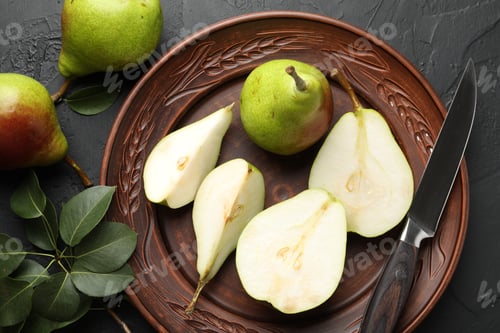 Preview: Fresh ripe pears, knife and green leaves on black table, flat lay
