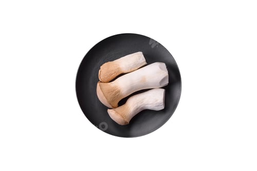 Preview: Pleurotus eryngii mushrooms on a dark concrete background