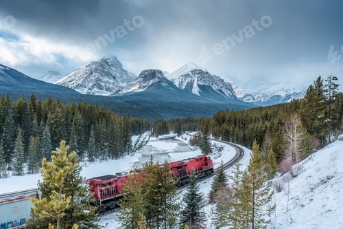Preview: Morants curve with canadian train passing the valley in winter at Banff national park