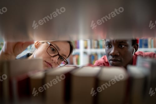Preview: Two diverse students searching sources for research project in university library