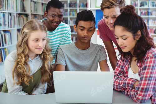 Preview: Attentive classmates using laptop in library
