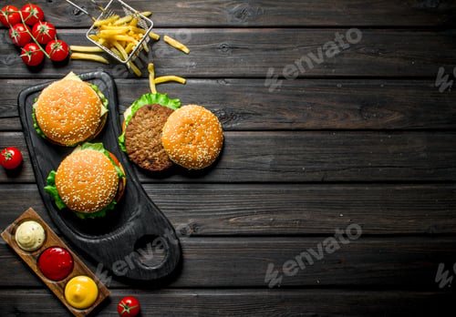 Preview: Burgers with fries, sauces and cherry.
