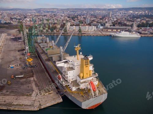 Preview: Aerial view of big cargo ship bulk carrier is loaded with coal in port