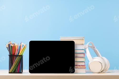 Preview: Tablet with colorful pencils and stack of books