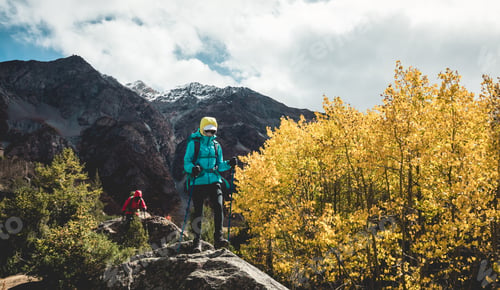 Preview: Two backpackers hiking in high altitude winter mountains