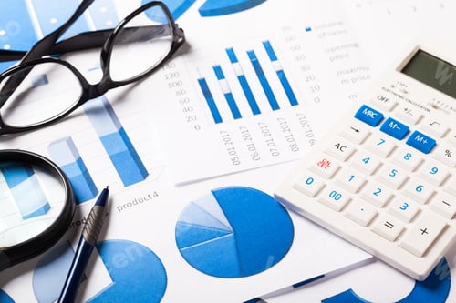 Preview: Business Graphs and Calculator on Office Desk