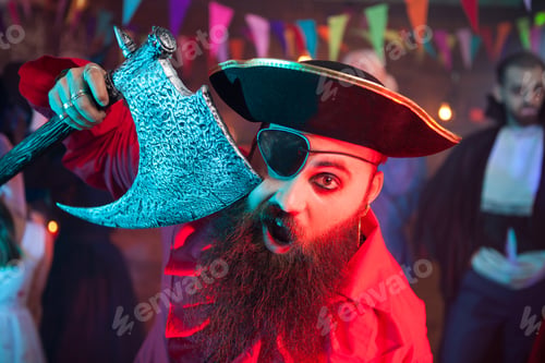 Preview: Portrait of cheerful bearded men dressed up like a pirate at a halloween party