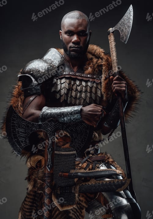 Preview: African guy dressed in military nordic costume holding an axe