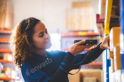 Preview: warehouse worker using bar code scanner to analyze newly arrived goods for further placement