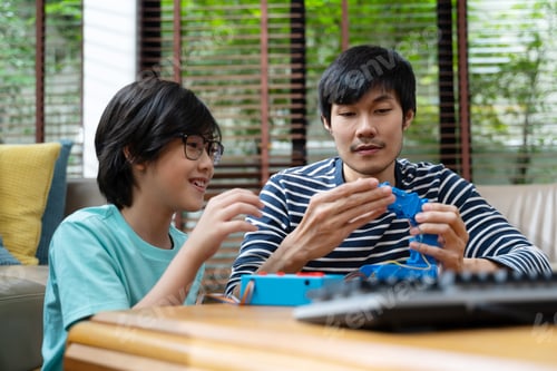 Preview: Asian kids program robotic cranes with laptops to learn about technology
