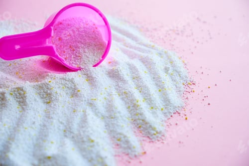 Preview: Measuring scoop with laundry powder on pink background