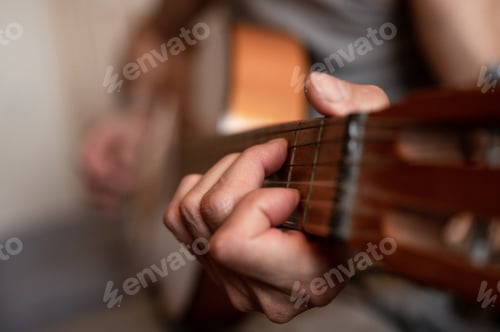 Preview: male hands elderly senior man holding playing classical guitar at home. guitarist play amateur music