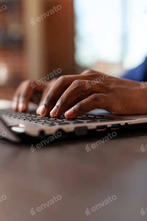 Preview: Close up of business man typing on laptop keyboard at office desk