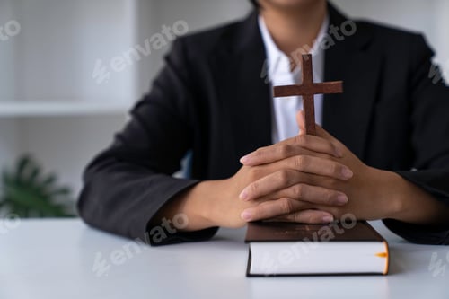 Preview: Christian woman holds bible in her hands. Reading the Holy Bible in a field during beautiful sunset.