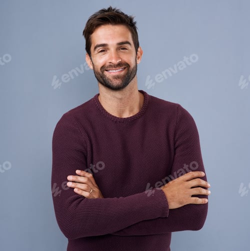 Preview: Studio shot of a handsome and confident young man posing against a gray background