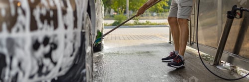 Preview: the man herself at the car wash washes the car with a brush