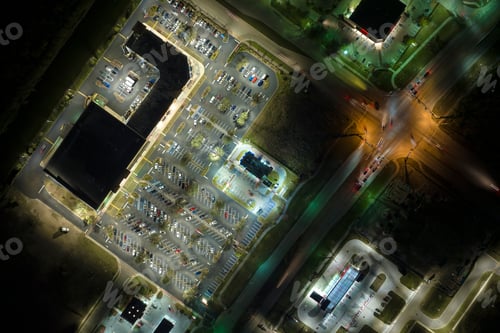 Preview: Aerial night view of many cars parked on parking lot with lines and markings