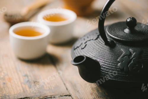Preview: Traditional asian herbal tea prepared in vintage cast iron teapot with organic dry herbs