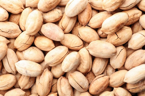 Preview: Pecan nuts in shell as background, top view. Nutritive food