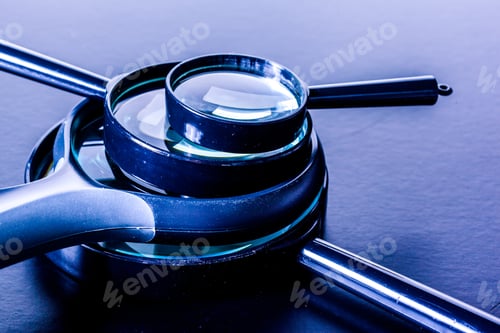 Preview: Closeup of magnifying glass on dark surface
