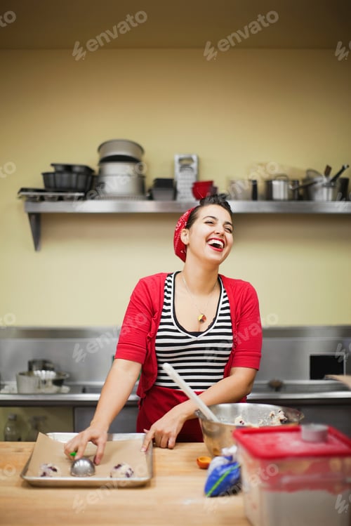 Preview: Young baker laughing while preparing food