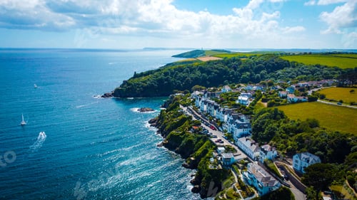 Preview: Aerial shot of the Falmouth Cornwall village on the coast of a beach surrounded by hills