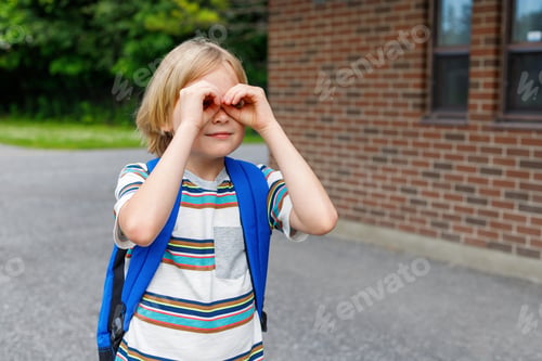 Preview: Little boy at school yard with backpack