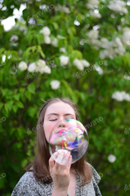 Preview: Girl blowing soap bubbles