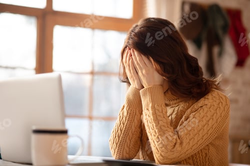 Preview: Woman with long hair closing her face in despair